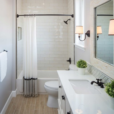 Bathroom - large transitional stone tile and white tile bathroom idea in Los Angeles with an undermount sink, white cabinets, gray walls and recessed-panel cabinets