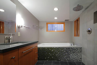 Large minimalist black tile, gray tile and glass tile ceramic tile bathroom photo in Seattle with flat-panel cabinets, medium tone wood cabinets, gray walls and an undermount sink