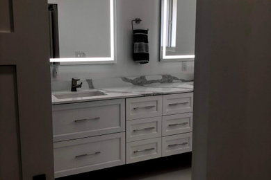 Bathroom - transitional master double-sink bathroom idea in Miami with shaker cabinets, white cabinets, quartz countertops and a floating vanity