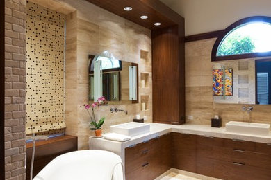Bathroom - large transitional master beige tile and travertine tile travertine floor and beige floor bathroom idea in Dallas with flat-panel cabinets, brown cabinets, a one-piece toilet, beige walls, a vessel sink, quartz countertops, a hinged shower door and white countertops