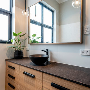 Inspiration for a mid-sized contemporary 3/4 bathroom in Perth with flat-panel cabinets, medium wood cabinets, grey walls, a vessel sink, grey floor, black benchtops and a built-in vanity.