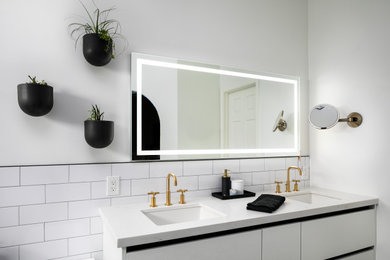 Bathroom - industrial master white tile and porcelain tile double-sink bathroom idea in Phoenix with flat-panel cabinets, white cabinets, white walls, a drop-in sink, quartzite countertops, white countertops and a floating vanity