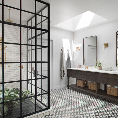 Example of a country white tile and subway tile corner shower design in San Francisco with furniture-like cabinets, dark wood cabinets, white walls, an undermount sink and a hinged shower door