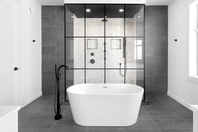 Freestanding bathtub - modern gray floor freestanding bathtub idea in Edmonton with white walls