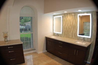 Inspiration for a transitional master glass tile travertine floor bathroom remodel in Tampa with an undermount sink, flat-panel cabinets, dark wood cabinets and granite countertops