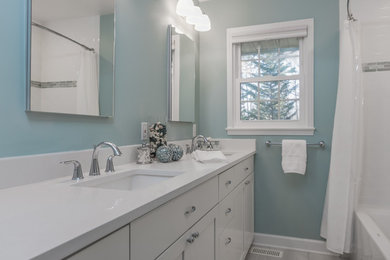 Inspiration for a mid-sized timeless kids' subway tile and blue tile gray floor and ceramic tile bathroom remodel in Raleigh with shaker cabinets, white cabinets, a one-piece toilet, an undermount sink, blue walls, quartz countertops and white countertops