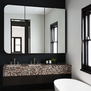 Photo of a contemporary bathroom in Melbourne with multi-coloured benchtops, a freestanding tub, white walls, an undermount sink and grey floor.