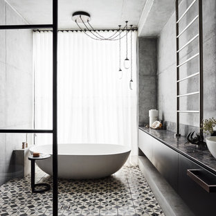 Inspiration for a large contemporary bathroom in Sydney with flat-panel cabinets, black cabinets, a freestanding tub, grey walls, a vessel sink, multi-coloured floor, black benchtops, a single vanity, a floating vanity, an open shower, cement tiles and an open shower.