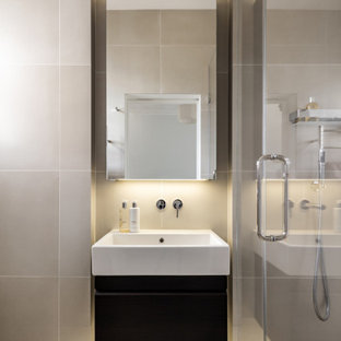 Photo of a medium sized contemporary shower room bathroom in London with flat-panel cabinets, black cabinets, an alcove shower, beige tiles, porcelain tiles, porcelain flooring, an integrated sink, beige floors, white worktops, a single sink and a floating vanity unit.