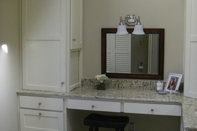 Photo of a medium sized classic ensuite bathroom in New Orleans with shaker cabinets, beige cabinets, beige walls, porcelain flooring, a submerged sink and granite worktops.