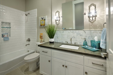 Inspiration for a mid-sized transitional 3/4 white tile and subway tile porcelain tile and beige floor bathroom remodel in Sacramento with shaker cabinets, white cabinets, a two-piece toilet, beige walls, an undermount sink and quartz countertops