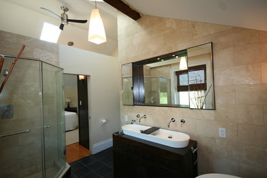 Example of a cottage beige tile corner shower design in Toronto with dark wood cabinets