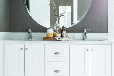 Example of a mid-sized transitional master white tile and subway tile marble floor and gray floor bathroom design in Boston with shaker cabinets, white cabinets, a two-piece toilet, gray walls, an undermount sink, marble countertops and a hinged shower door