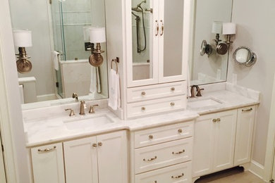 Bathroom - mid-sized transitional master white tile and mosaic tile light wood floor and beige floor bathroom idea in Other with recessed-panel cabinets, white cabinets, pink walls, an undermount sink, marble countertops, a hinged shower door and a one-piece toilet