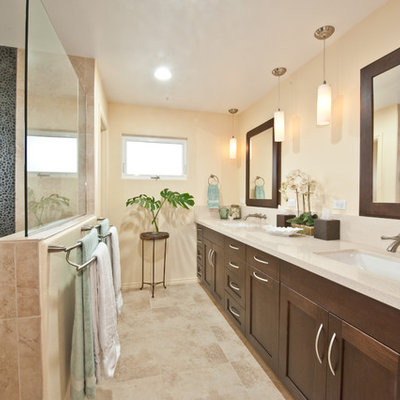 Inspiration for a mid-sized transitional master beige tile travertine floor and beige floor bathroom remodel in Hawaii with an undermount sink, shaker cabinets, solid surface countertops, beige walls and dark wood cabinets