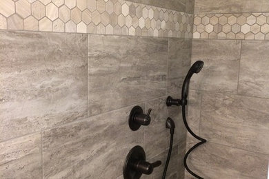 Mid-sized elegant gray tile and ceramic tile porcelain tile and brown floor bathroom photo in Other with beaded inset cabinets, white cabinets, beige walls, an undermount sink and granite countertops