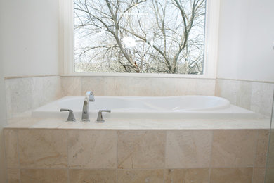 Large master beige tile and stone tile travertine floor bathroom photo in Kansas City with white cabinets, a hot tub and white walls