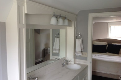 Example of a small transitional master bathroom design in Minneapolis with shaker cabinets, white cabinets, gray walls and an undermount sink