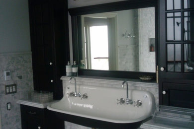 Mid-sized minimalist master gray tile and white tile bathroom photo in Los Angeles with shaker cabinets, black cabinets, a two-piece toilet, blue walls, a wall-mount sink and marble countertops
