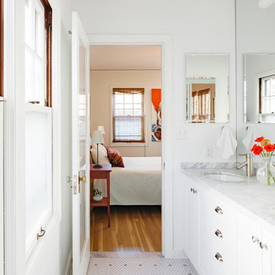Mid-sized elegant master white tile and ceramic tile ceramic tile alcove shower photo in Portland with an undermount sink, white cabinets, recessed-panel cabinets, a two-piece toilet, white walls, marble countertops and white countertops