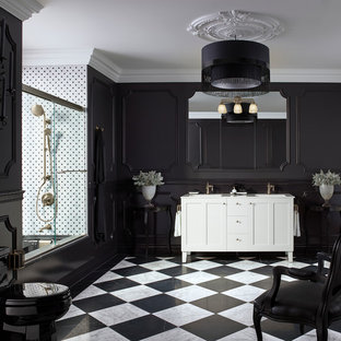 Design ideas for a contemporary bathroom in Miami with flat-panel cabinets, dark wood cabinets, an alcove tub, a shower/bathtub combo, a wall-mount toilet, black and white tile, black walls, linoleum floors, a vessel sink, solid surface benchtops, black floor and a hinged shower door.