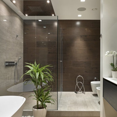 Freestanding bathtub - mid-sized contemporary master light wood floor freestanding bathtub idea in Moscow with flat-panel cabinets, dark wood cabinets and a wall-mount toilet