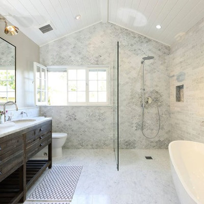 Inspiration for a transitional bathroom remodel in Los Angeles with an undermount sink, furniture-like cabinets, dark wood cabinets and a two-piece toilet