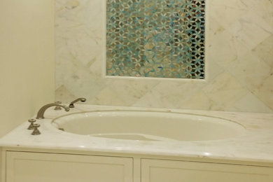 White tile bathroom photo in Los Angeles with marble countertops