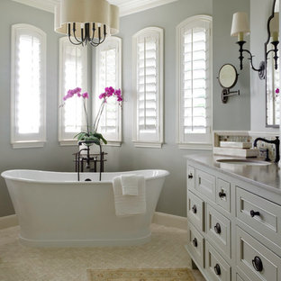 Example of a mid-sized classic master white tile and stone tile travertine floor bathroom design in Austin with an undermount sink, furniture-like cabinets, gray cabinets, limestone countertops and blue walls