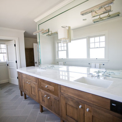 Inspiration for a timeless stone tile bathroom remodel in San Diego with an undermount sink, shaker cabinets and dark wood cabinets