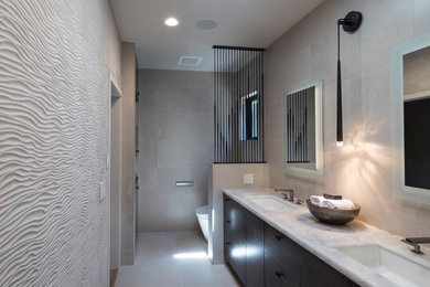 Example of a mid-sized minimalist master gray tile and ceramic tile ceramic tile and gray floor bathroom design in San Francisco with flat-panel cabinets, medium tone wood cabinets, a one-piece toilet, gray walls, an undermount sink, quartzite countertops and beige countertops