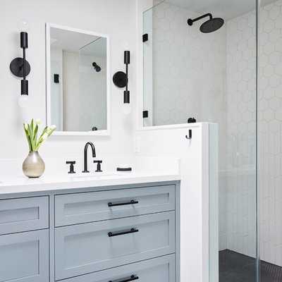 Transitional master white tile and ceramic tile ceramic tile and gray floor double shower photo in San Francisco with shaker cabinets, blue cabinets, white walls, an undermount sink, quartz countertops, a hinged shower door and white countertops