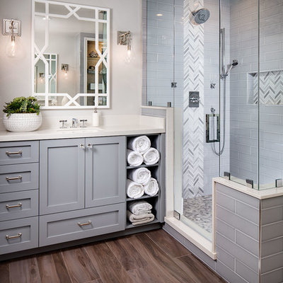 Transitional master gray tile and subway tile medium tone wood floor bathroom photo in San Diego with gray cabinets, gray walls, an undermount sink and a hinged shower door