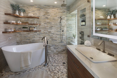 Inspiration for a contemporary master beige tile and porcelain tile pebble tile floor, multicolored floor and double-sink bathroom remodel in Orange County with flat-panel cabinets, medium tone wood cabinets, beige walls, a vessel sink, quartz countertops, beige countertops and a built-in vanity