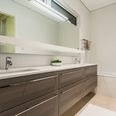 Trendy alcove bathtub photo in Perth with flat-panel cabinets, brown cabinets, white walls and an undermount sink