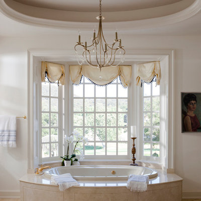 Inspiration for a large timeless master beige tile and stone tile drop-in bathtub remodel in Los Angeles with white walls