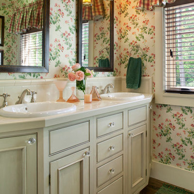 Example of a classic beige tile bathroom design in Other with a drop-in sink, recessed-panel cabinets, green cabinets, tile countertops and multicolored walls