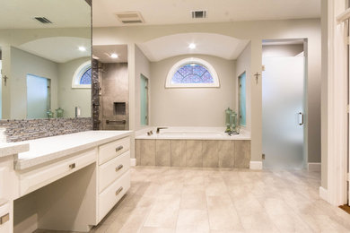 Design ideas for a medium sized classic ensuite bathroom in Houston with flat-panel cabinets, white cabinets, a submerged bath, an alcove shower, matchstick tiles, grey walls, porcelain flooring, a submerged sink, quartz worktops, beige floors and a hinged door.