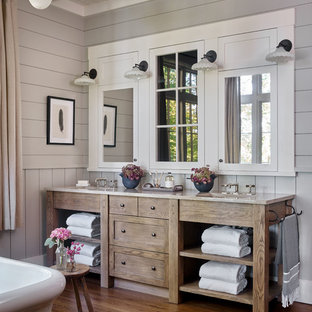 Country bathroom with furniture-like cabinets, medium wood cabinets, grey walls, medium hardwood floors, an undermount sink, brown floor and grey benchtops.