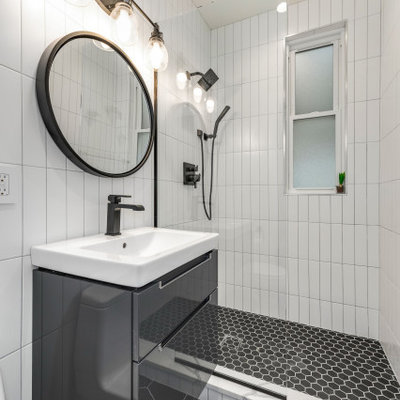 Inspiration for a small contemporary 3/4 white tile and porcelain tile porcelain tile and black floor bathroom remodel in Chicago with furniture-like cabinets, gray cabinets, a one-piece toilet, solid surface countertops, white countertops and an integrated sink