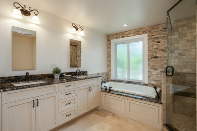 Large transitional master beige tile and stone tile porcelain tile bathroom photo in Denver with recessed-panel cabinets, beige cabinets, a two-piece toilet, white walls, an undermount sink and granite countertops