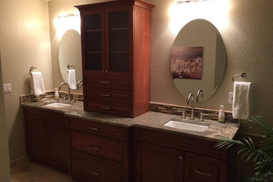 Example of a mid-sized classic master beige tile and porcelain tile porcelain tile bathroom design in Denver with an undermount sink, raised-panel cabinets, medium tone wood cabinets, granite countertops, a two-piece toilet and beige walls