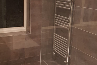 Photo of a contemporary bathroom in Surrey with grey tiles, ceramic tiles, ceramic flooring and grey floors.