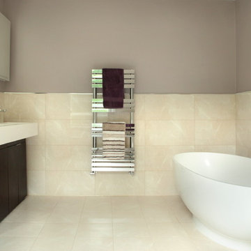 Large modern bathroom with freestanding oval bath