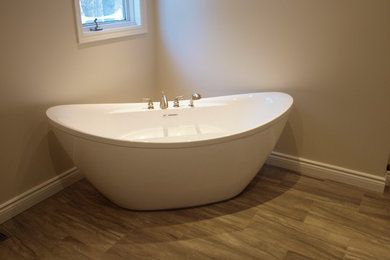 Example of a large minimalist master beige tile and porcelain tile porcelain tile bathroom design in Ottawa with a vessel sink, furniture-like cabinets, dark wood cabinets, quartz countertops and beige walls