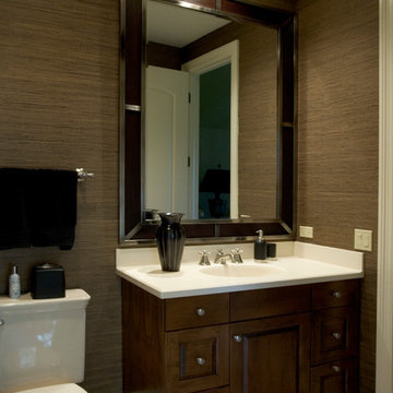 Large wood mirror trimmed in metal and grass cloth walls