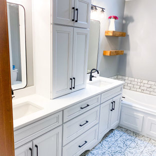 This is an example of a small shabby-chic style master bathroom in Kansas City with recessed-panel cabinets, white cabinets, a drop-in tub, an open shower, a two-piece toilet, gray tile, marble, grey walls, porcelain floors, an undermount sink, engineered quartz benchtops, multi-coloured floor, a hinged shower door, white benchtops, a double vanity and a built-in vanity.