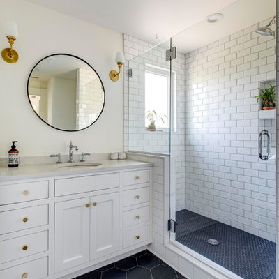 Example of a large classic white tile and subway tile porcelain tile and black floor alcove shower design in Portland with recessed-panel cabinets, white cabinets, beige walls, an undermount sink, quartzite countertops, a hinged shower door and white countertops