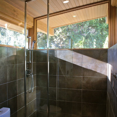 Trendy gray tile pebble tile floor bathroom photo in Seattle