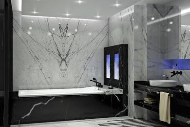 Example of a large minimalist master black and white tile and marble tile marble floor bathroom design in Other with open cabinets, black cabinets, a bidet, white walls, marble countertops and an undermount tub